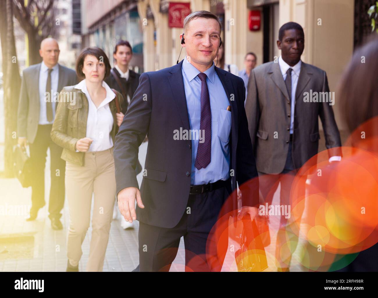 Business man walking on city street Stock Photo - Alamy