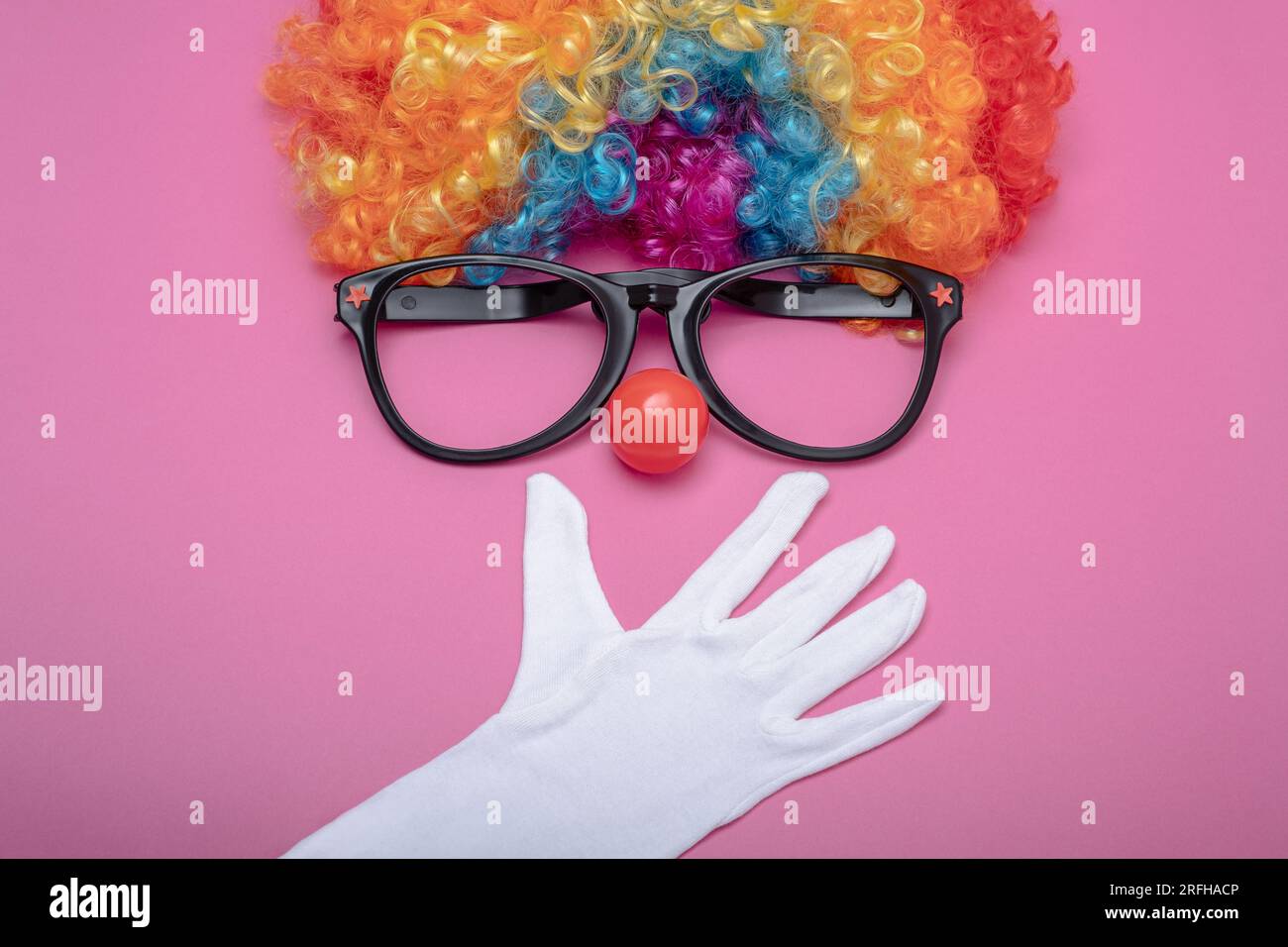 Funny Party concept surprised face formed with gloves. Rainbow Clown ...