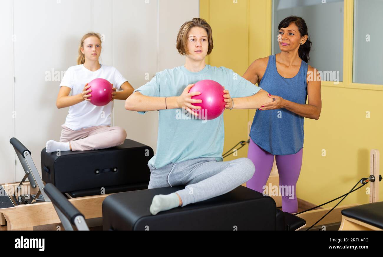 Pilates Instructor Shows Boy How To Exercise With Ball Stock Photo Alamy pilates-instructor-shows-boy-how-to-exercise-with-ball-stock-photo-alamy