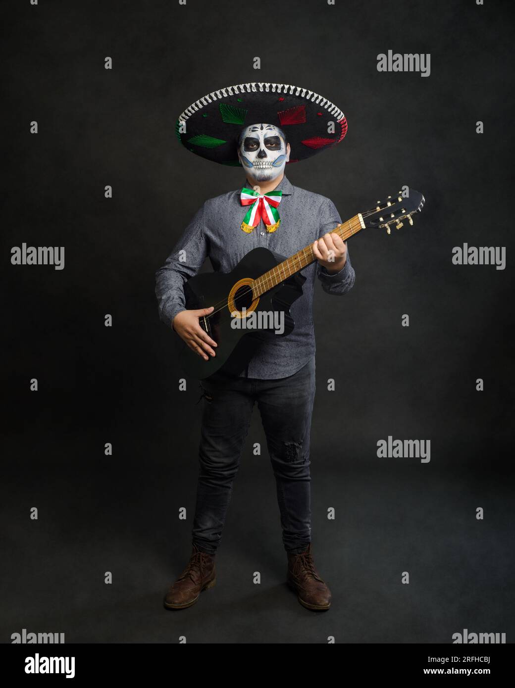 Portrait of catrin with mariachi hat and guitar. Day of the dead