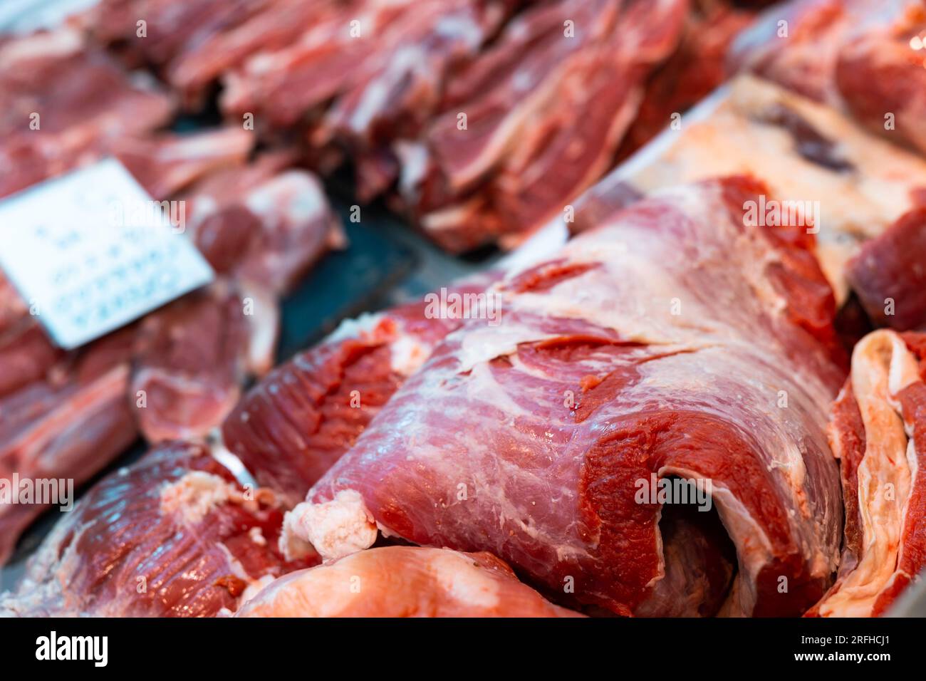 Slice of raw beef tenderloin and veal in packing tray on window