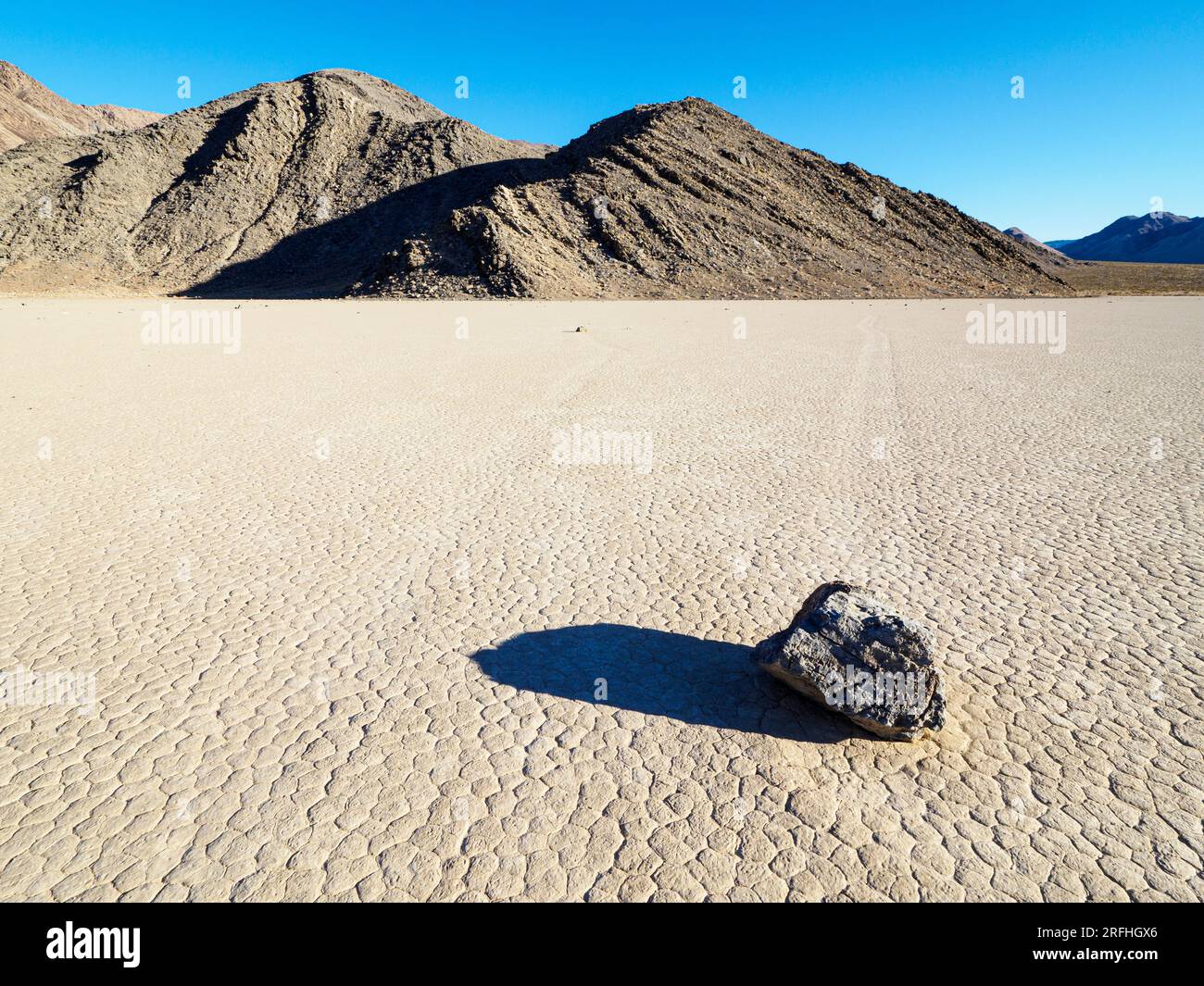A moving rock at the Racetrack, a playa or dried up lakebed, in Death Valley National Park, California, USA. Stock Photo