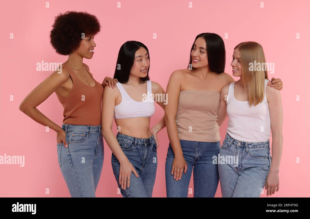 Portrait of beautiful young women on pink background Stock Photo - Alamy