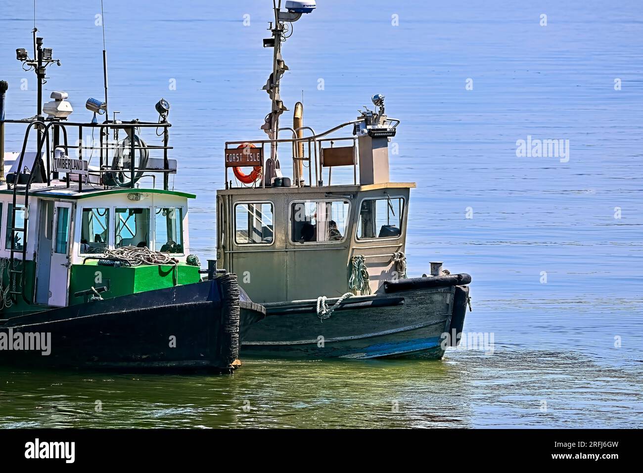 Two working tug boats tied together at a dock on Vancouver Island ...