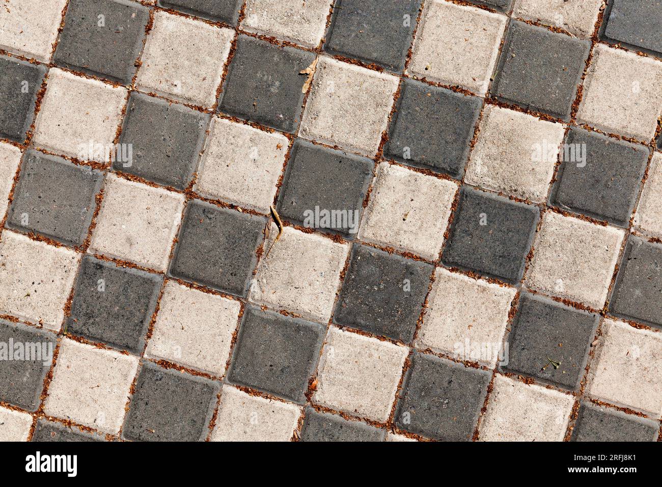 black and light tiles in a checkerboard pattern on the road, the road ...
