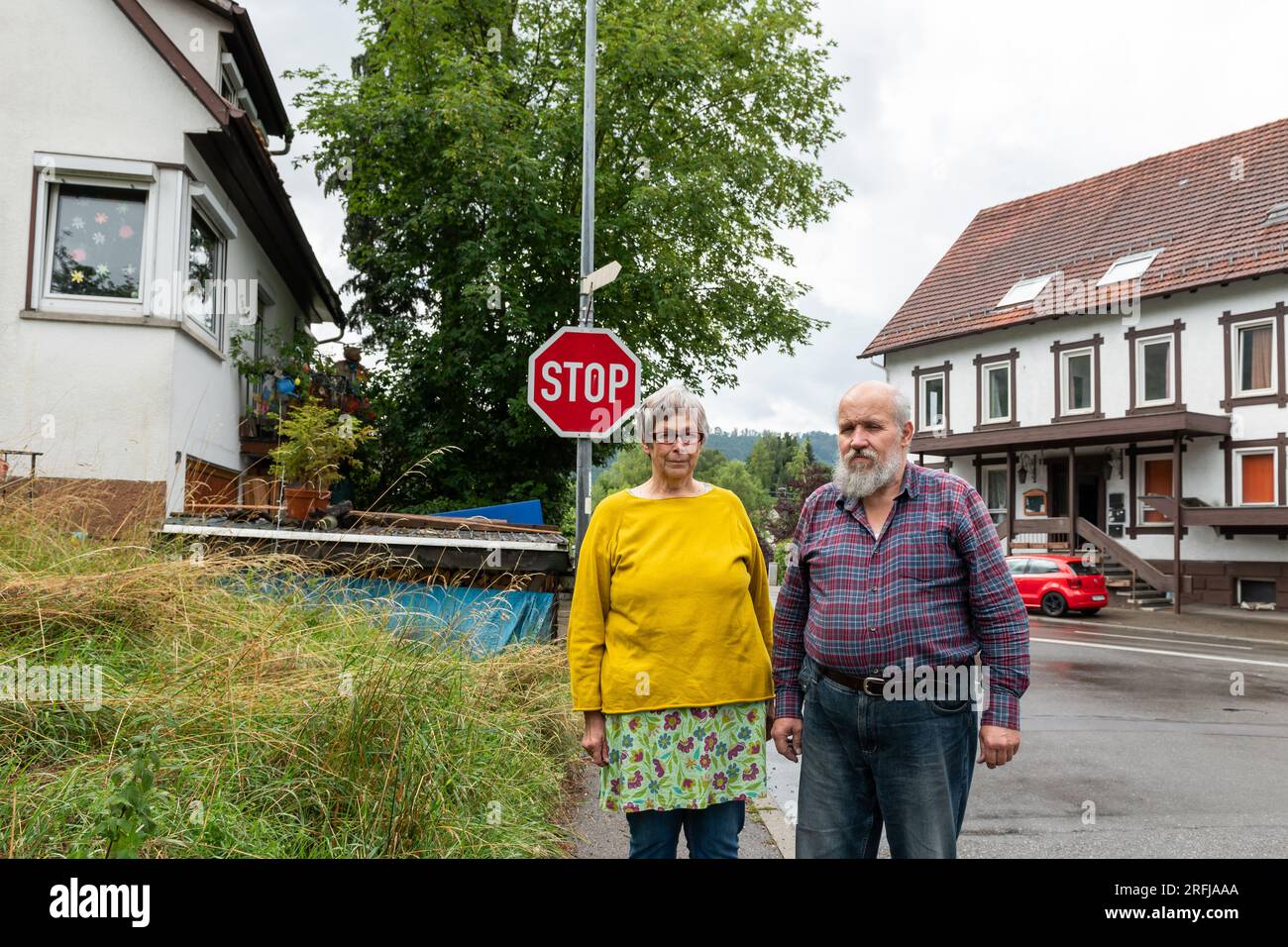 Burladingen, Germany. 26th July, 2023. Monika and Haiko Scherer stand in  front of their house (l) opposite the Lamm inn. Refugees are to be  accommodated in the former inn in the village