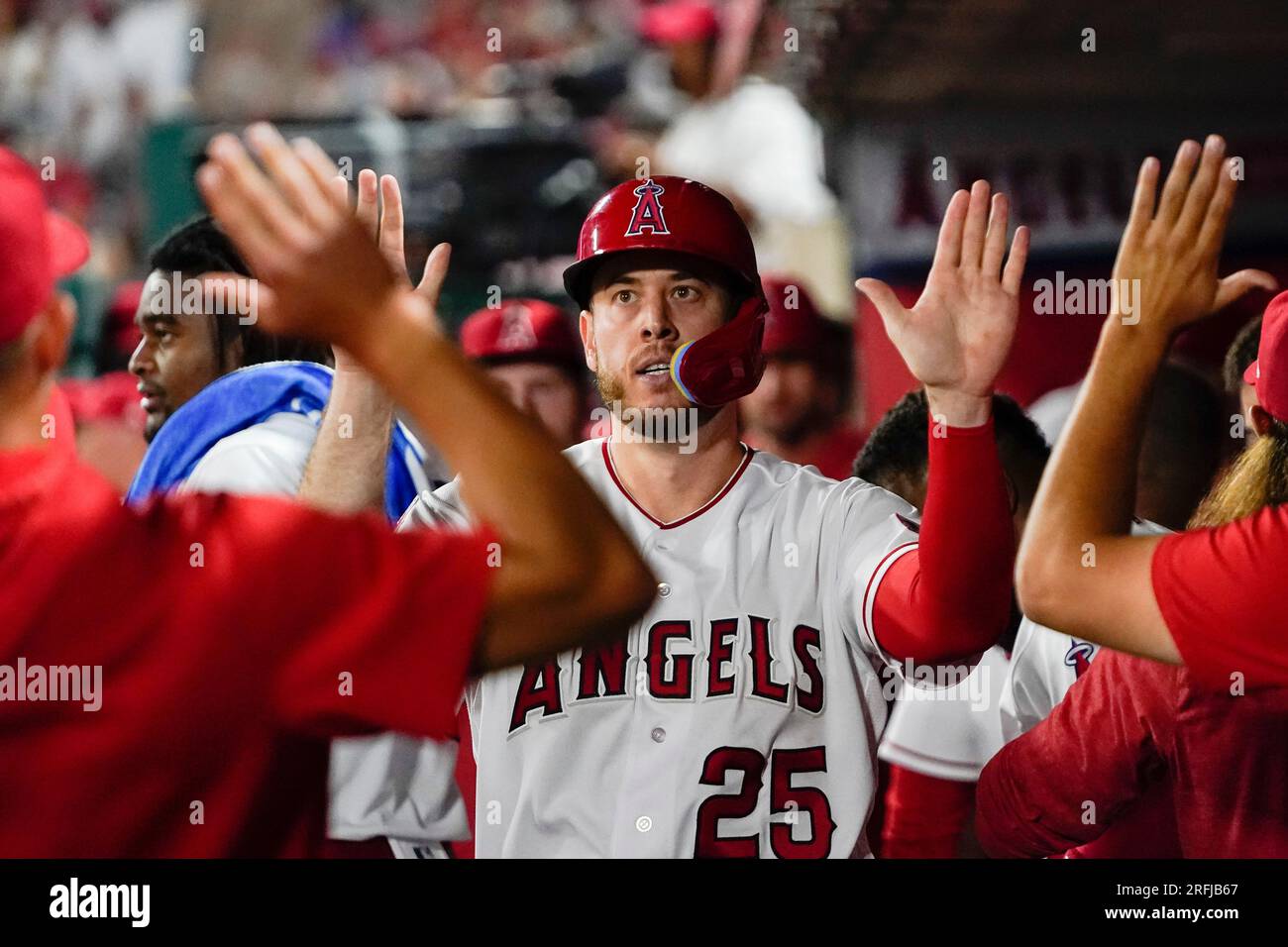 Los Angeles Angels' C.J. Cron (25) celebrates in the dugout after scoring  on a double by Mike Moustakas against the Seattle Mariners during the sixth  inning of a baseball game Thursday, Aug.