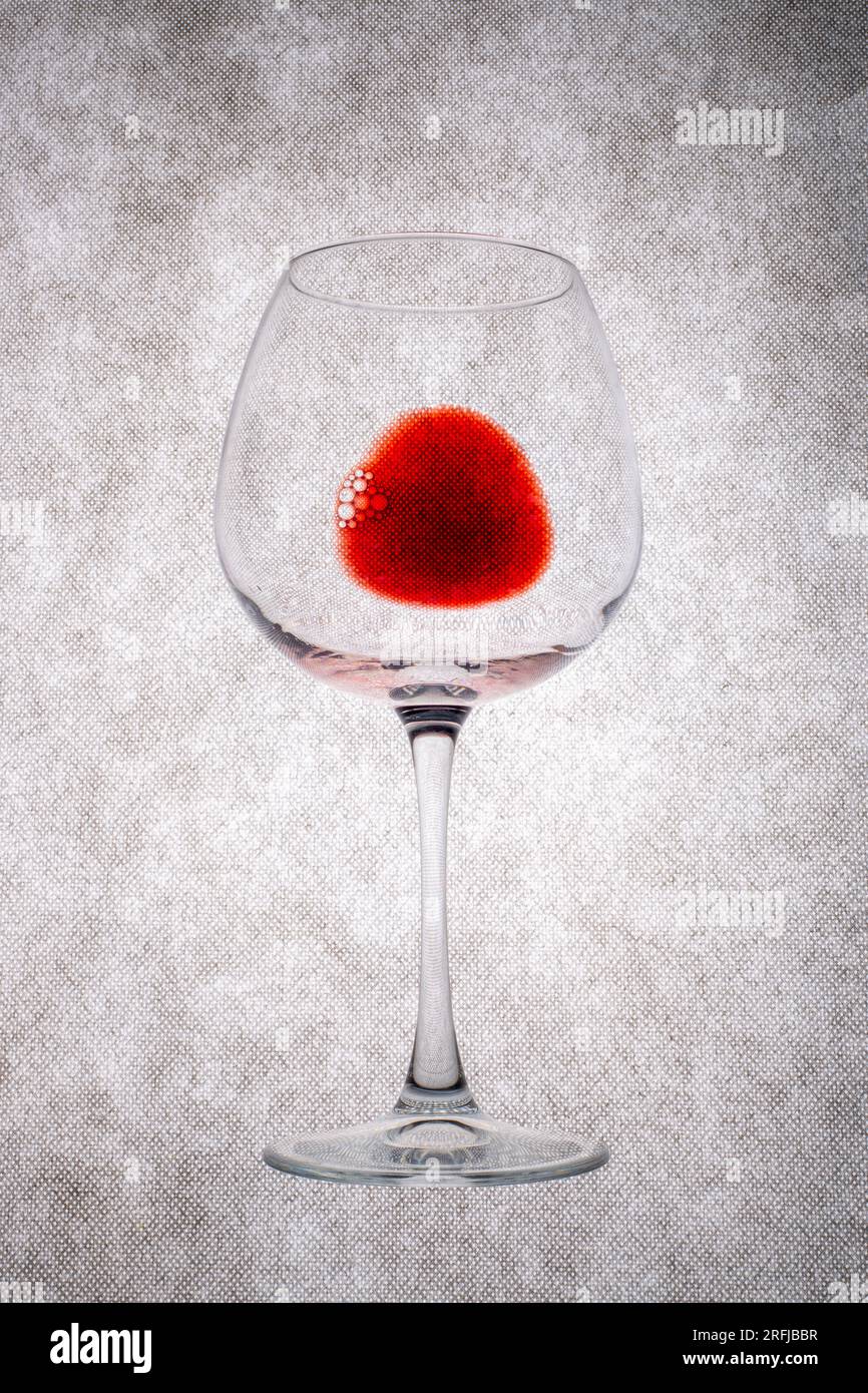 https://c8.alamy.com/comp/2RFJBBR/a-glass-of-red-wine-on-a-gray-background-2RFJBBR.jpg