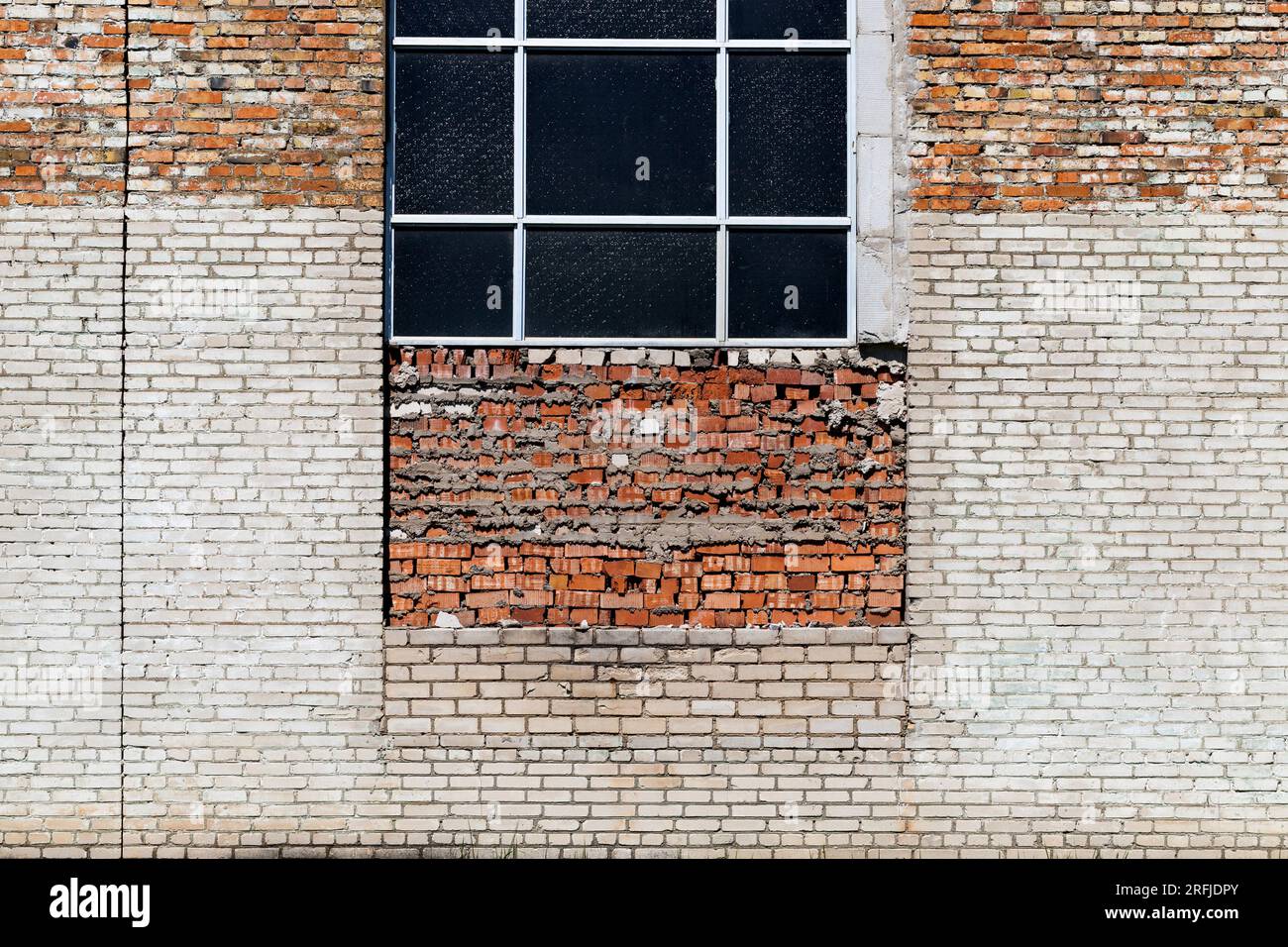 the wall of the building is made of different quality and types of bricks and blocks, mixed