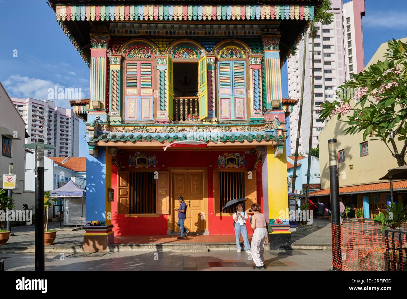 Two female tourists are taking photos in front of the multi-colored House of Tan Teng Niah, an old Chinese merchant's villa; Little India, Singapore Stock Photo