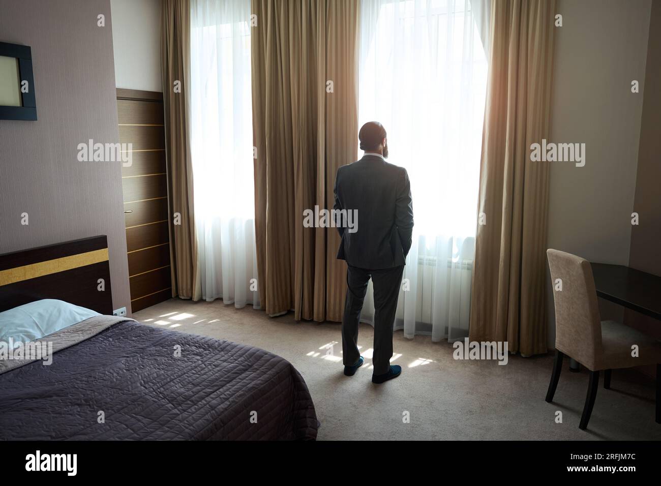 Hotel guest stands at the window in the sleeping area Stock Photo Alamy