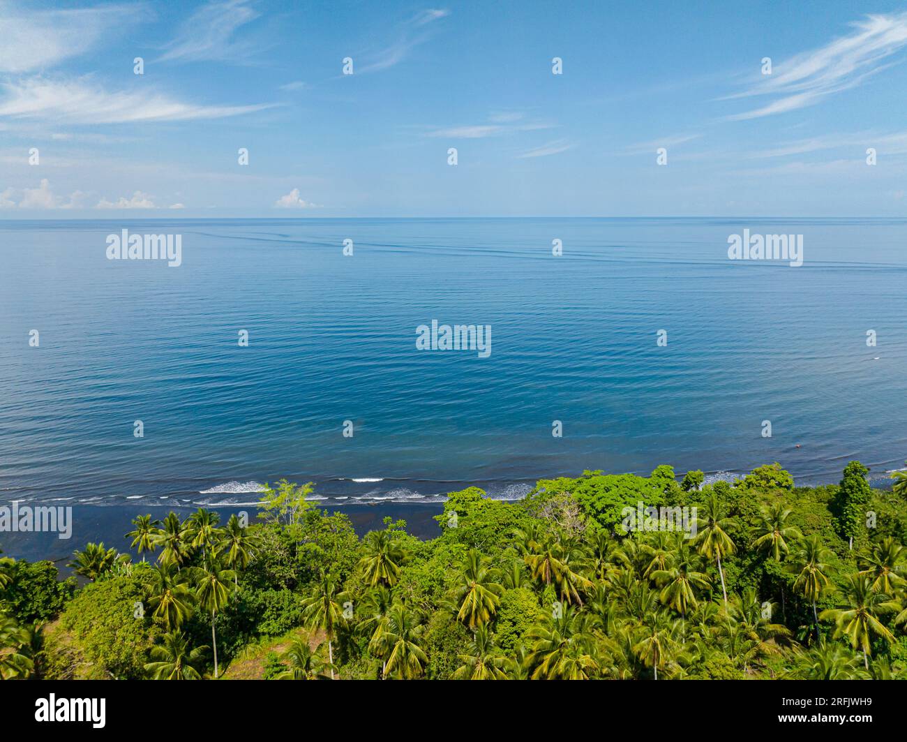 Tropical Island with Beautiful ocean waves in the shore. Blue sea and