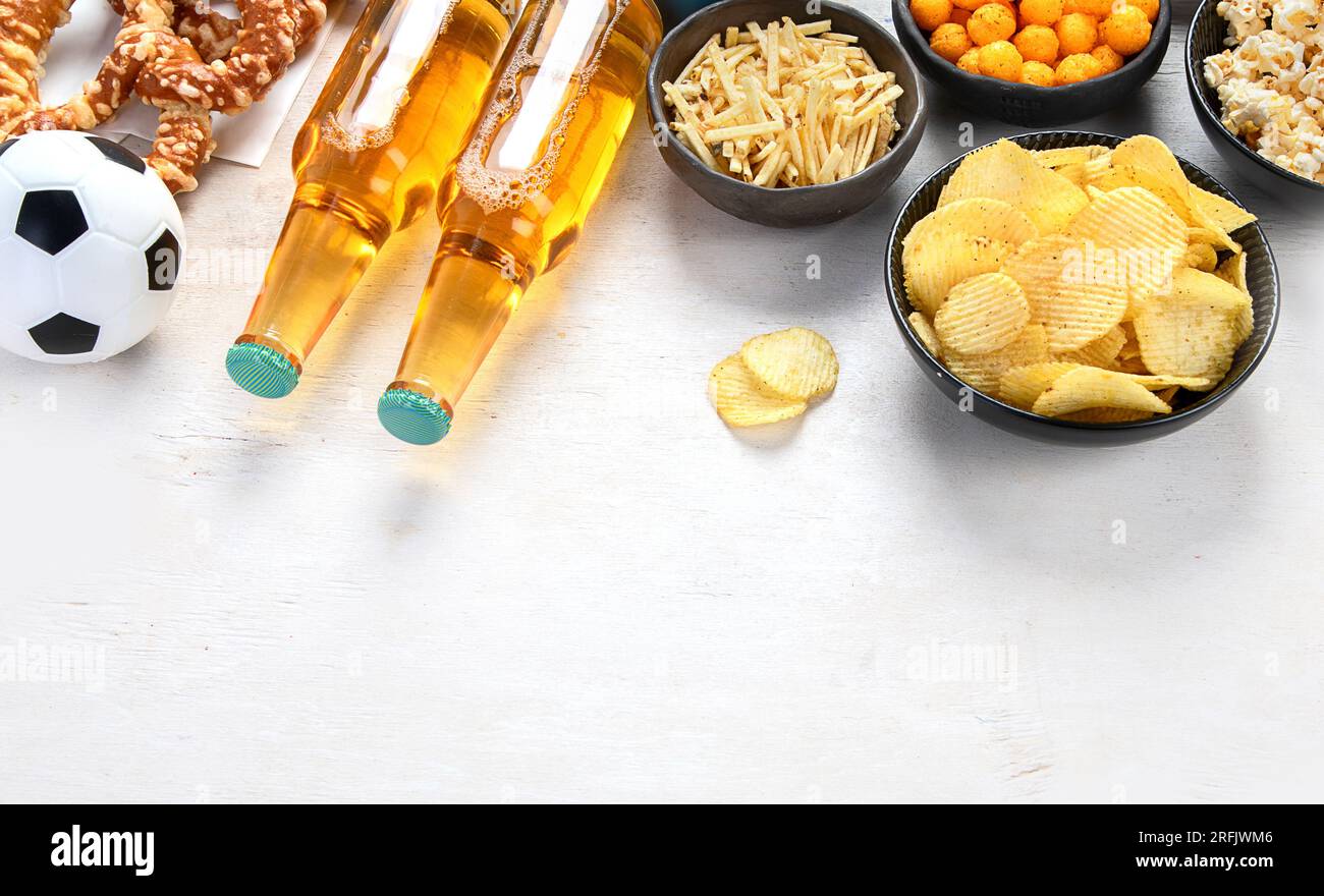 Beer bootles, snacks and ball on table. Top view, copy space Stock ...