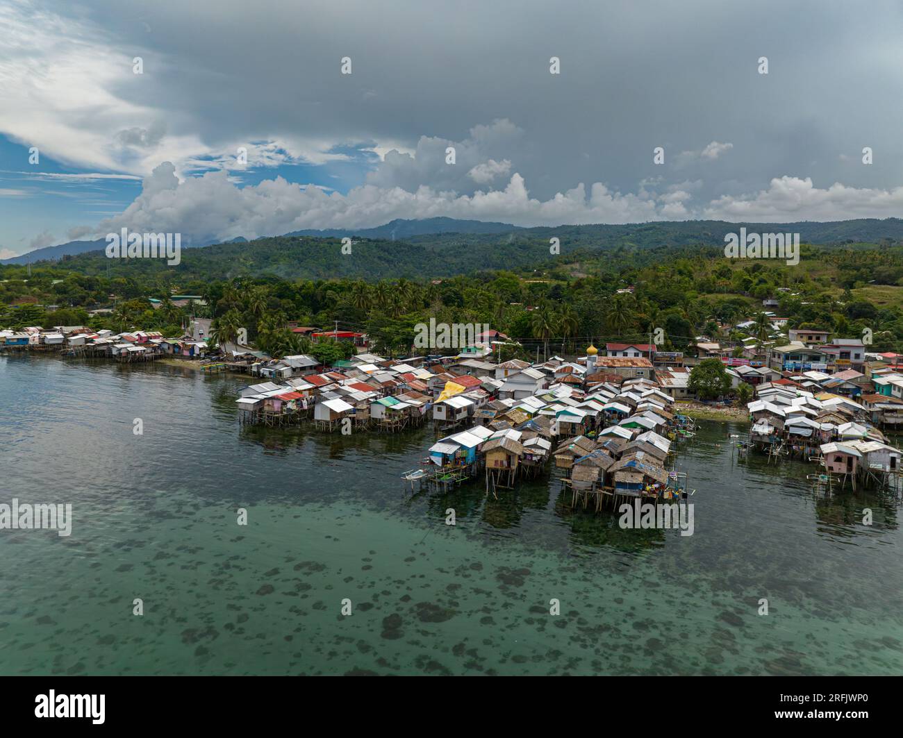 Village of fishermen with wooden houses on the water, with fishing boats. Zamboanga. Philippines, Mindanao. Stock Photo