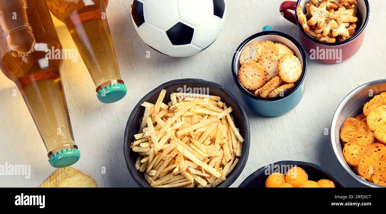 Beer bootles, snacks and ball on table. Top view, copy space Stock ...