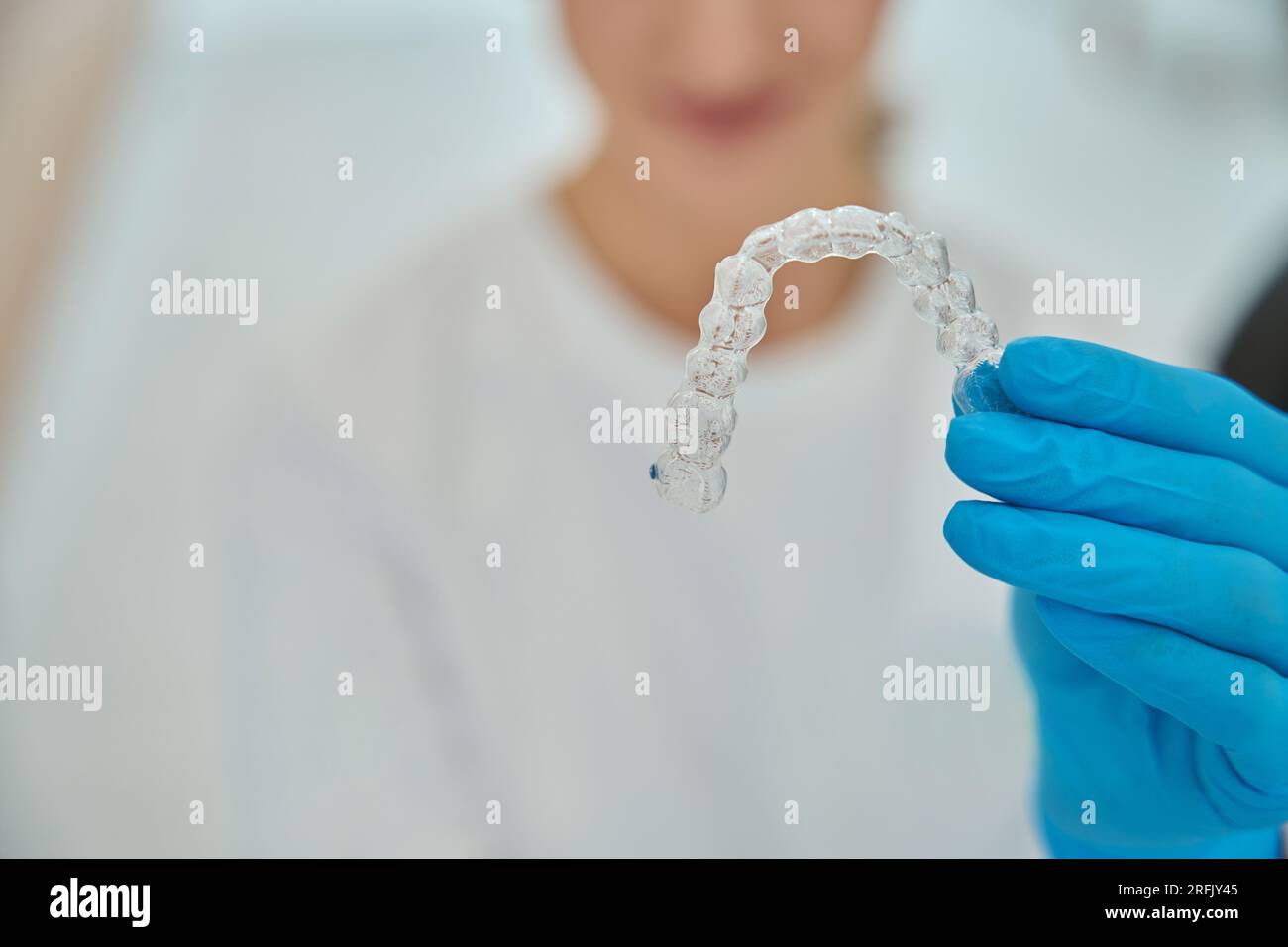 Stomatologist holding invisible removable aligners for teeth ...