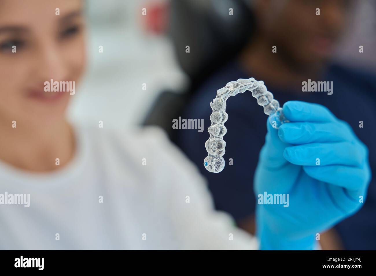 Dental technician holding invisible braces, or clear aligners Stock ...