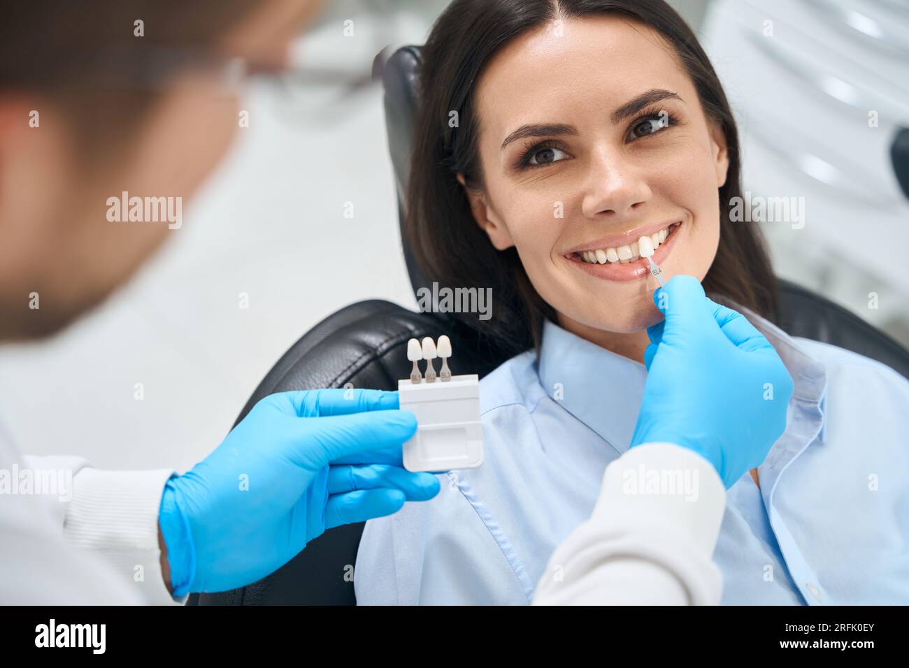 Male doctor stomatologist applying dental crown probe at female client teeth Stock Photo Alamy