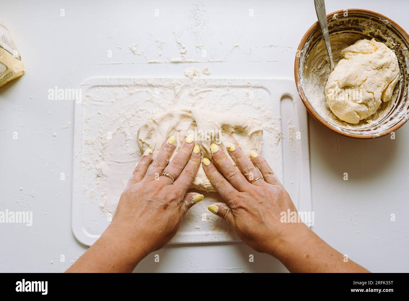 Female hands knead dough Stock Photo