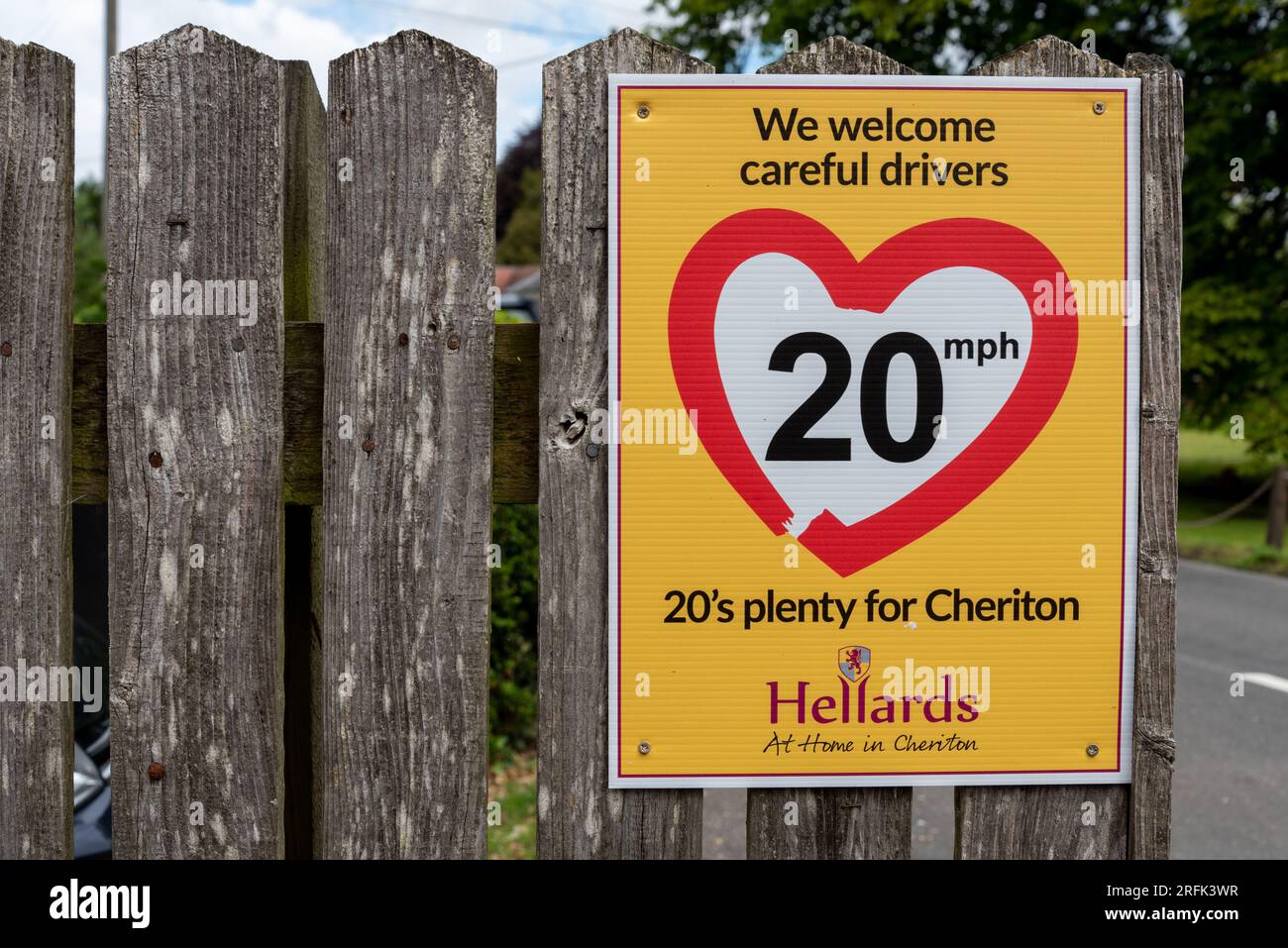 Bright yellow sign informing drivers that 20 mph is enough through rural villages. August 2023 Stock Photo