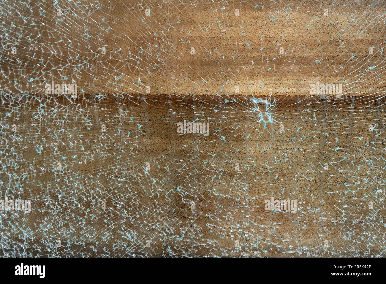 Random and abstract image of shattered glass after being broken from an impact hit. Stock Photo