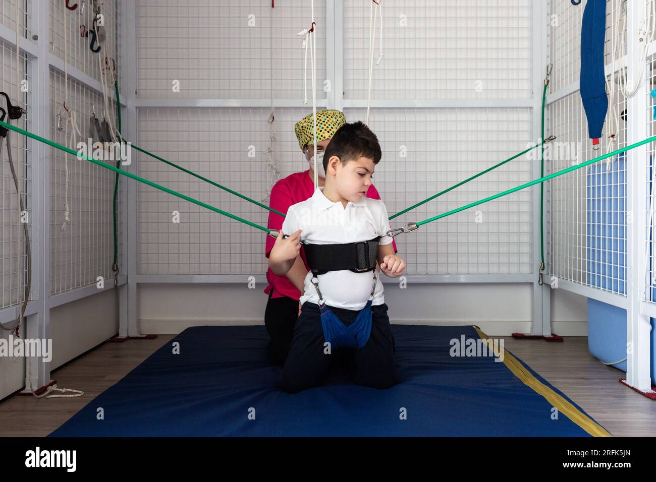 physical therapy room, physically disabled child exercising with