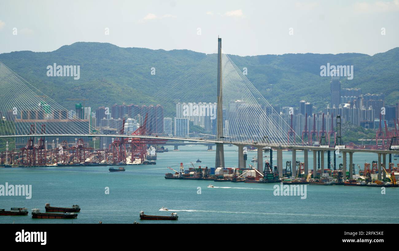 Kwai Tsing container terminal port view in drone, and hong kong skyline and stonecutter's bridge Stock Photo