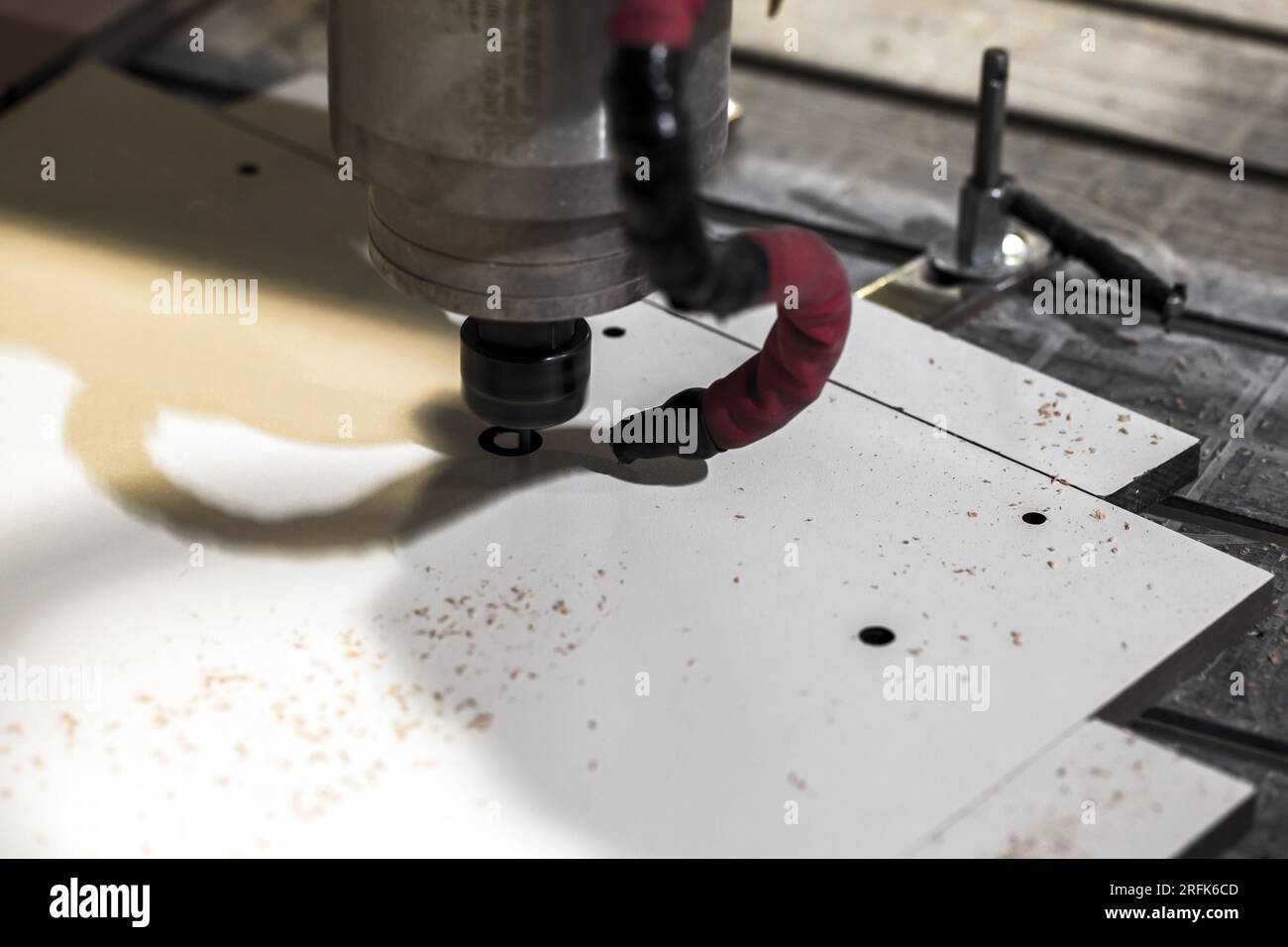 CNC milling machine close-up photo with selective soft focus. End mill processes a detail Stock Photo