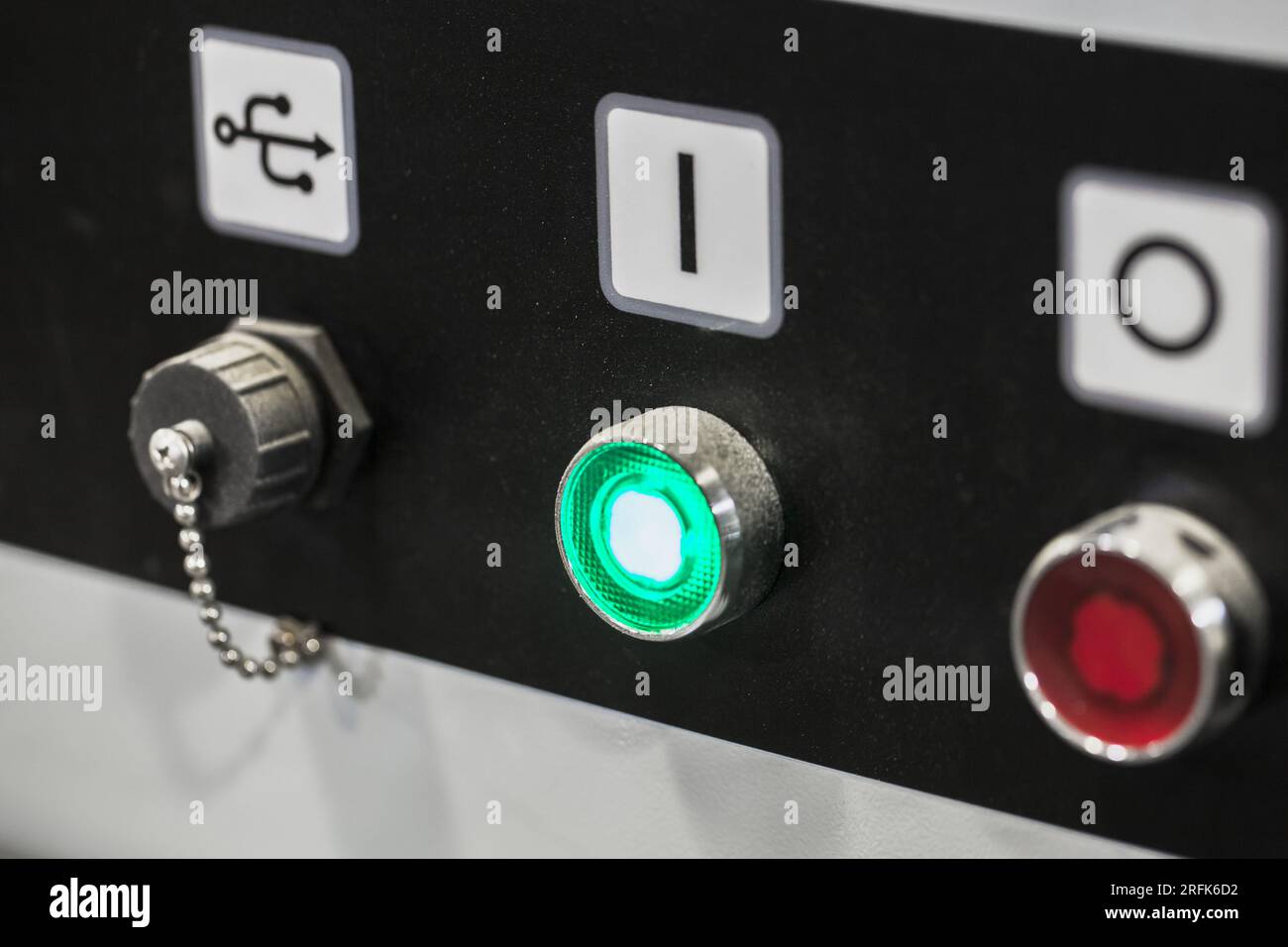 Industrial control panel with start stop buttons and closed USB socket, close-up photo with selective soft focus Stock Photo