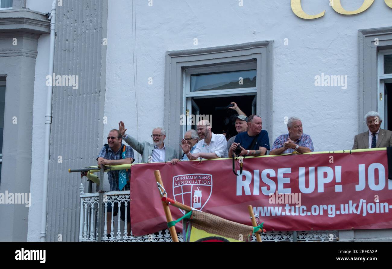 Jeremy Corbyn, Ken Loach and Jamie Driscoll on balcony of County Hotel watching procession at Miners' Gala Stock Photo