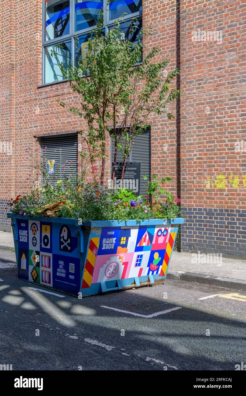 Reusing an old skip, Bankside's Metal Box Garden. A series of unusual planting schemes in Bankside. Creating more tranquil streets in London. Stock Photo