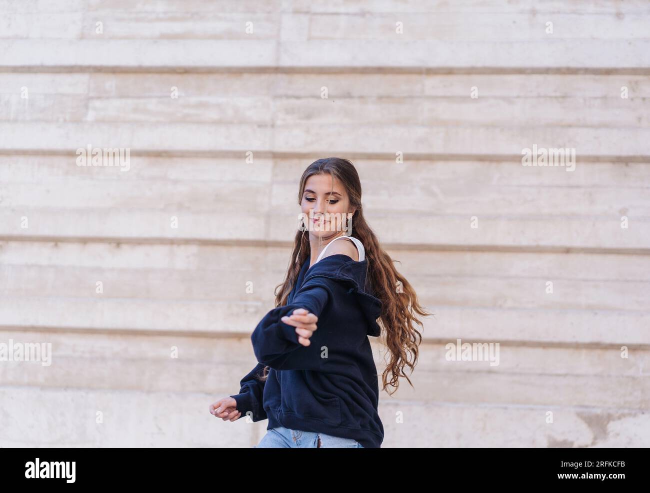 Girl Dancing Next To A Modern Wall Stock Photo Alamy