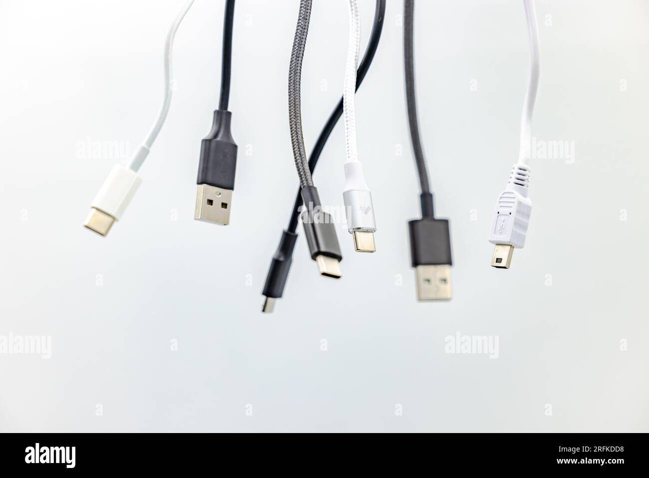 Various black and white USB type A and type C cables and connectors cropped in studio against white background Stock Photo