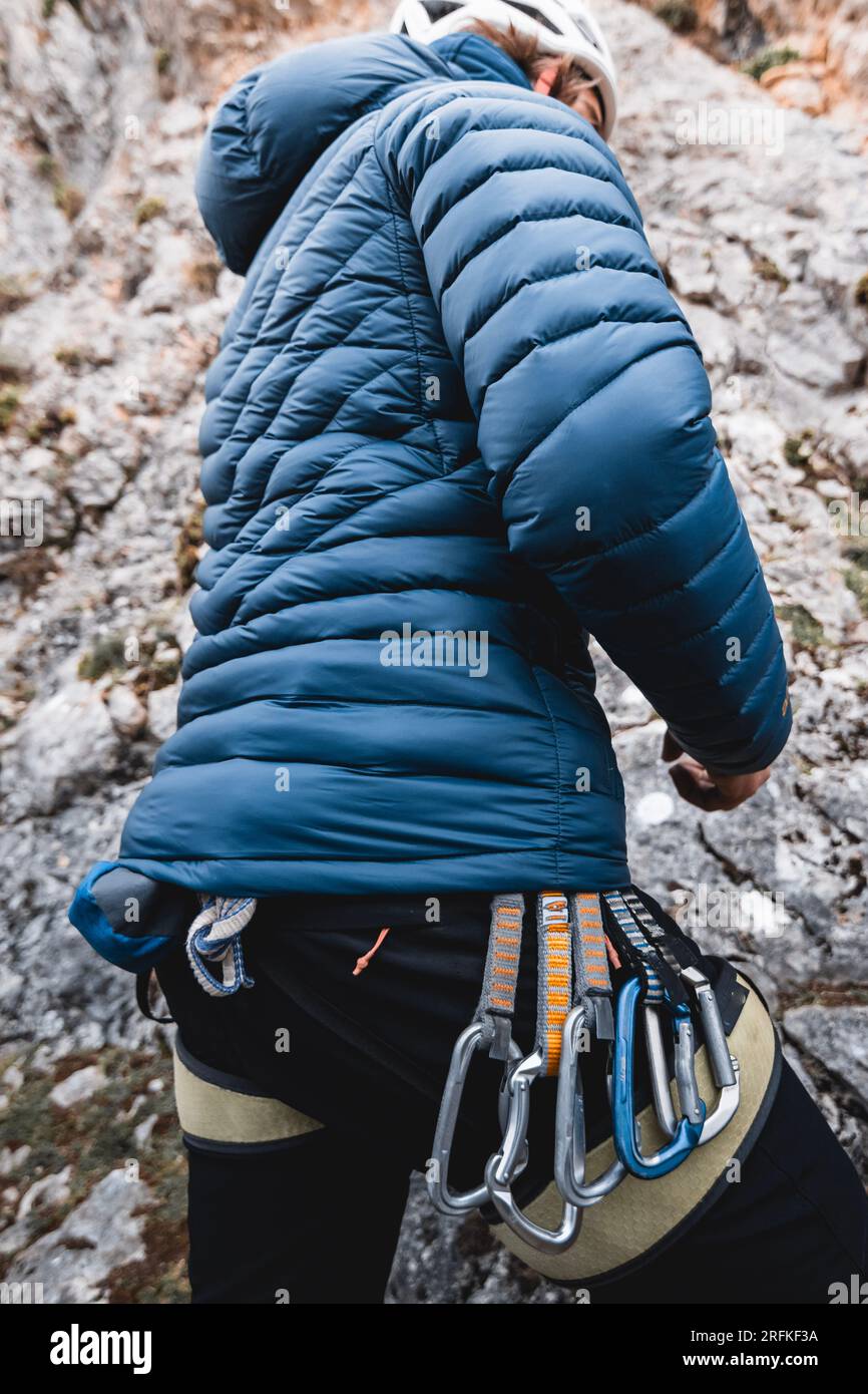 Climbing equipment, carabiners, hanging from the harness of a man while