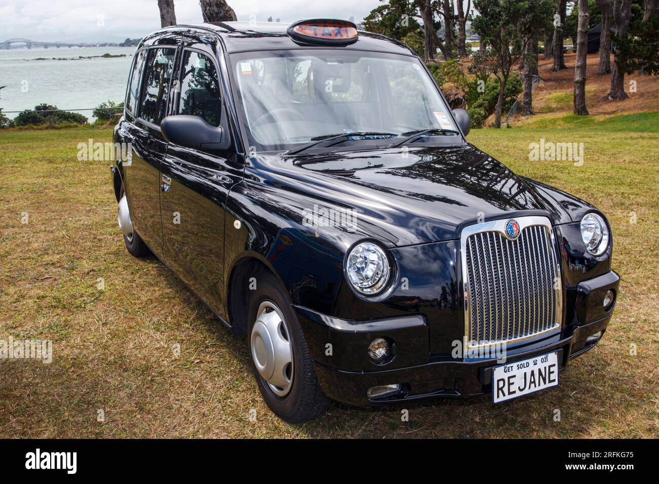 A London Black Taxi Cab parked on grass in New Zealand Stock Photo
