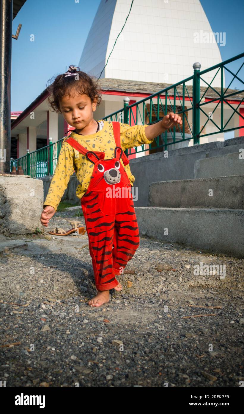 Oct.14th 2022 Uttarakhand, India. Young Indian child stumbling with eyes closed while walking outdoors. Adorable and candid moment captured. Stock Photo