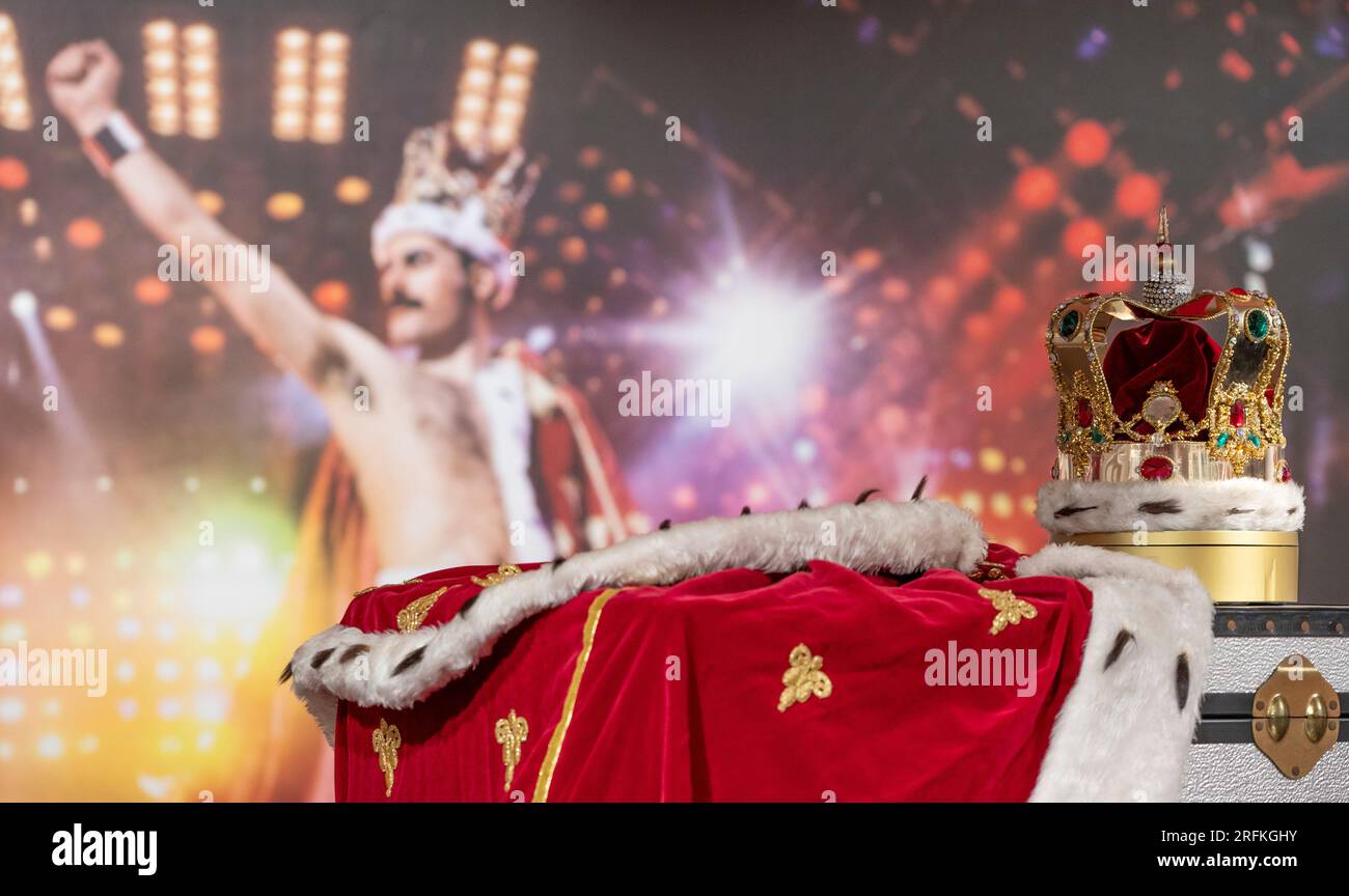 Sotheby’s, London, UK. 3 August 2023. An exhibition of the contents of Freddie Mercury’s London home filling Sotheby’s London Galleries, on view 4 Aug-5 Sept. Image: Freddie Mercury’s crown and accompanying cloak, in fake fur, red velvet and rhinestones, made by his friend and costume designer Diana Moseley, thought to be loosely modelled on the coronation crown of the UK. Indelibly linked to Mercury, they were worn for the finale rendition of “God Save The Queen” during his last tour with Queen. Iconic background image by Denis O'Regan. Crown estimate £60,000–80,000. Credit: Malcolm Park/Alam Stock Photo