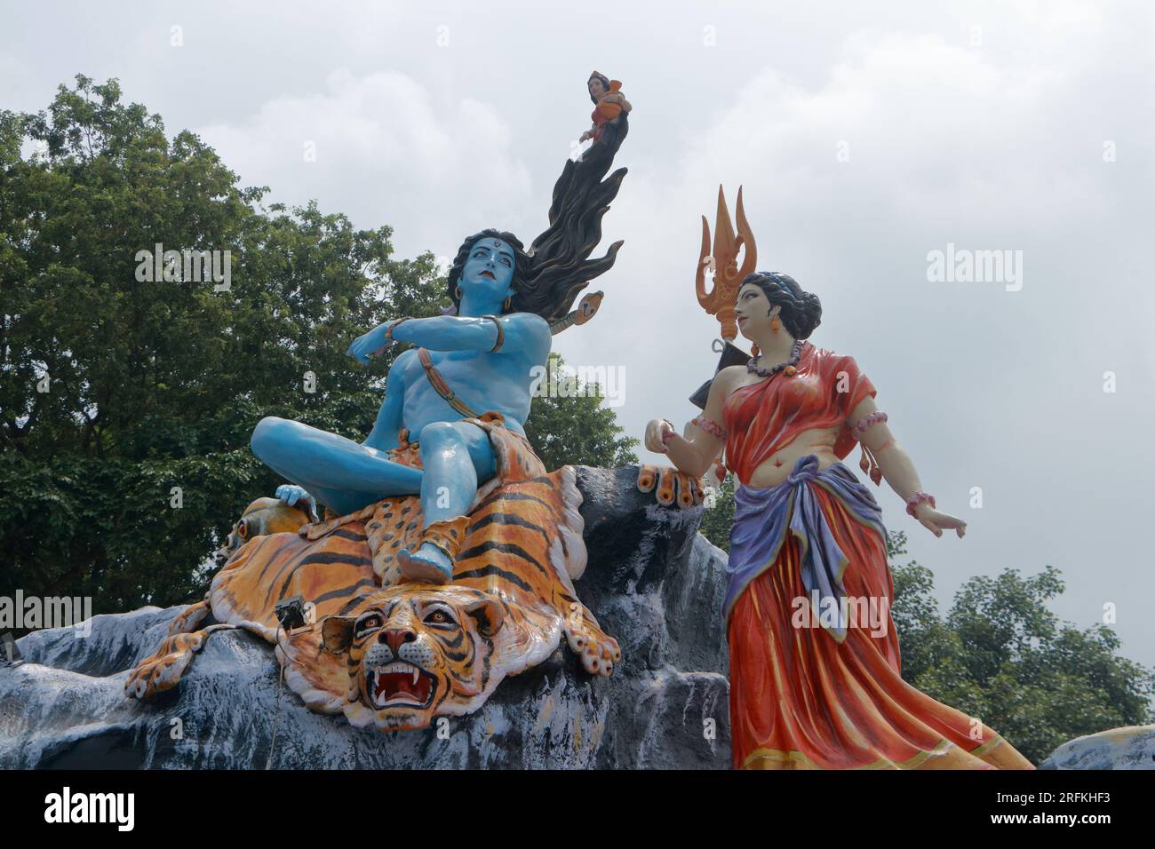 Giant statue of Lord Shiva and Parvati at Triveni Ghat, Rishikesh, with Lord Shiva sitting on the back of a tiger and Goddess Ganga. Stock Photo