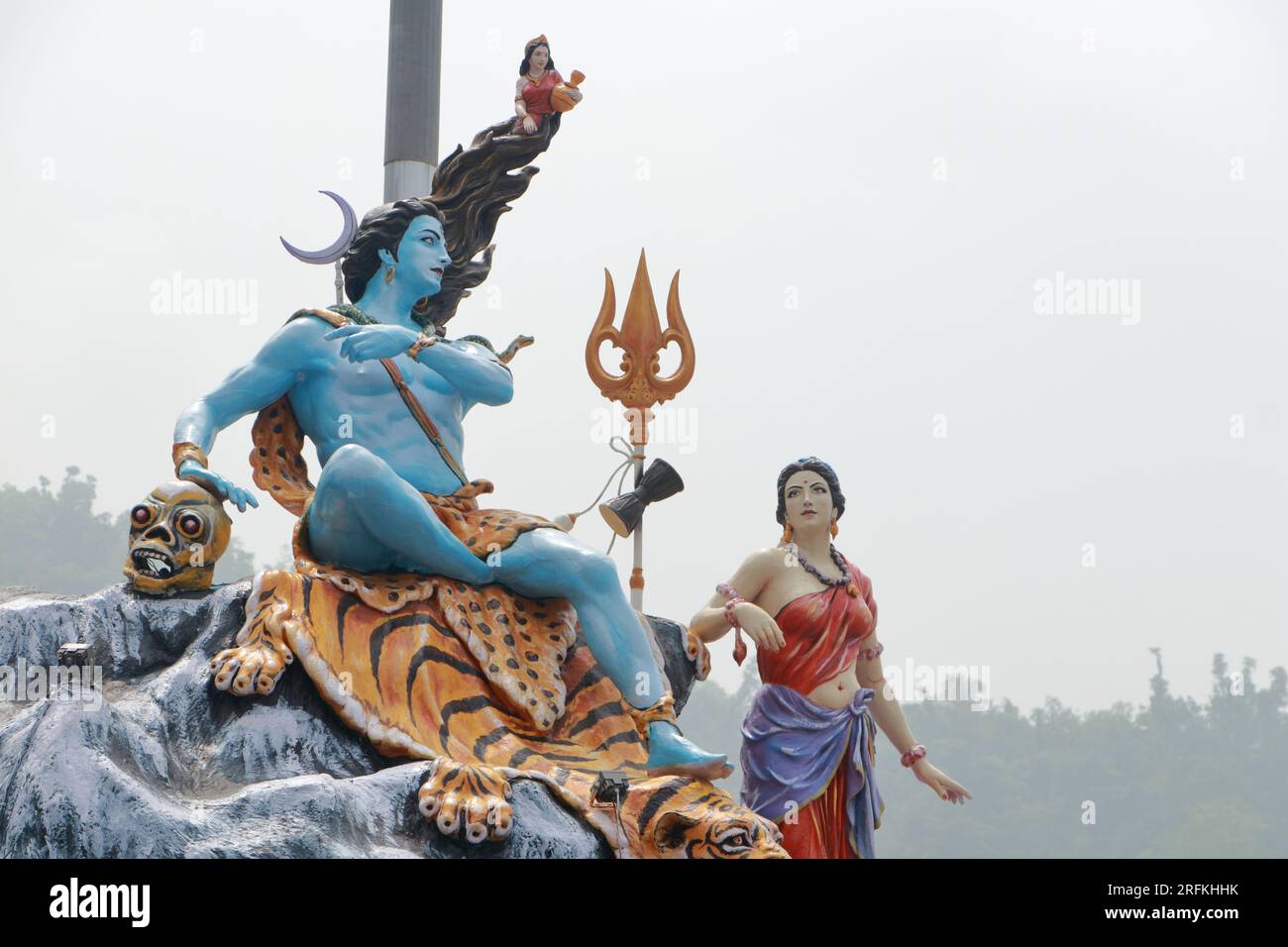 Giant statue of Lord Shiva and Parvati at Triveni Ghat, Rishikesh, with Lord Shiva sitting on the back of a tiger and Goddess Ganga. Stock Photo