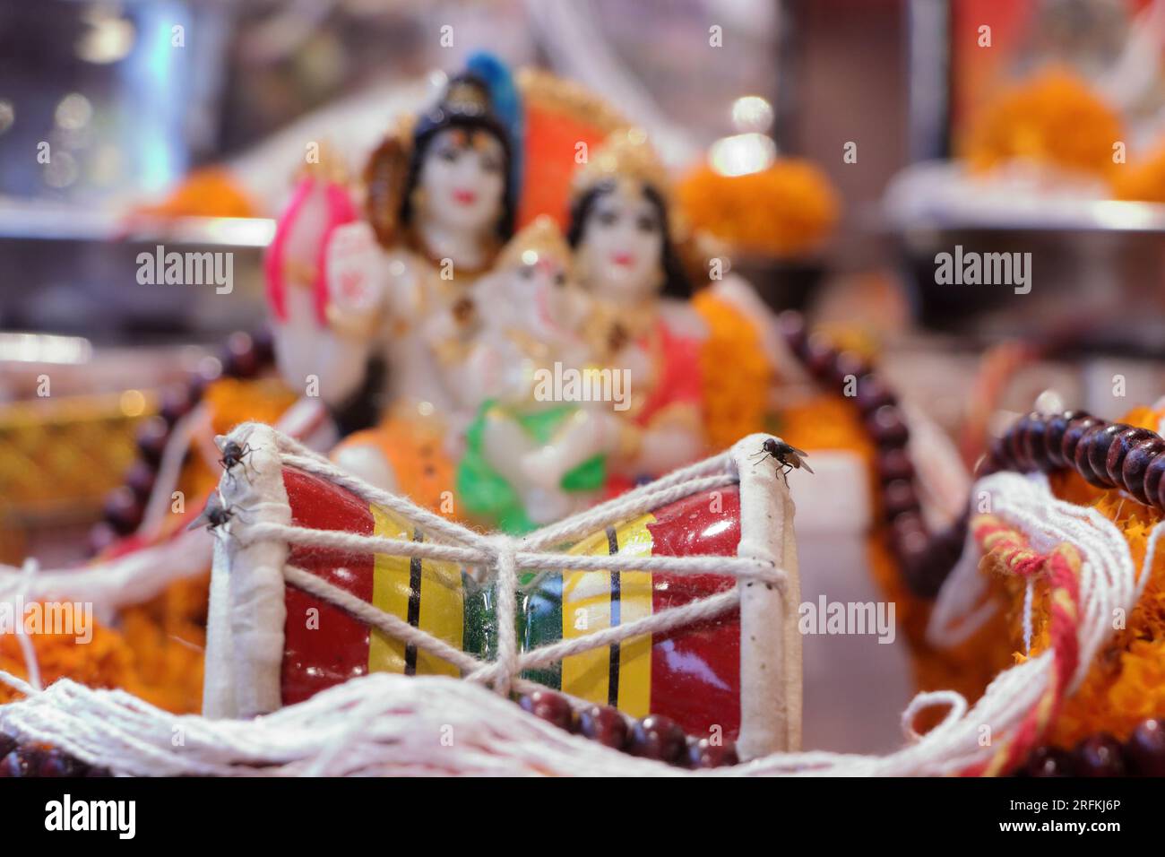 Damru, with the idol of Lord Shiva Parvati With different focus, Damru is a small musical instrument. Stock Photo