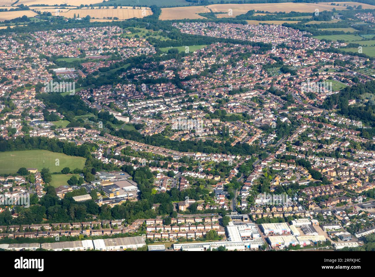 Oblique aerial view through plane window of housing estates in
