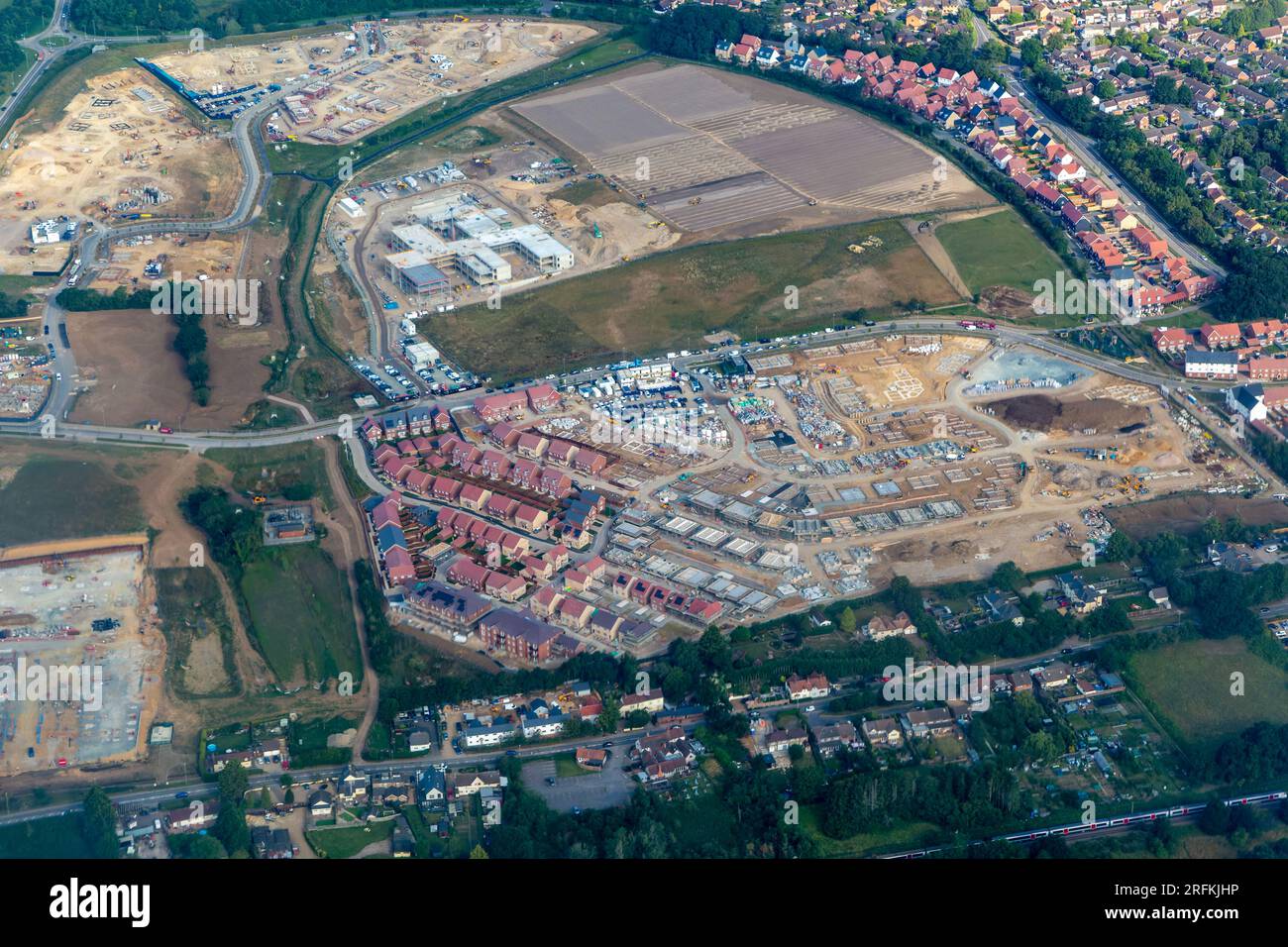 Oblique aerial view through plane window of construction of new housing