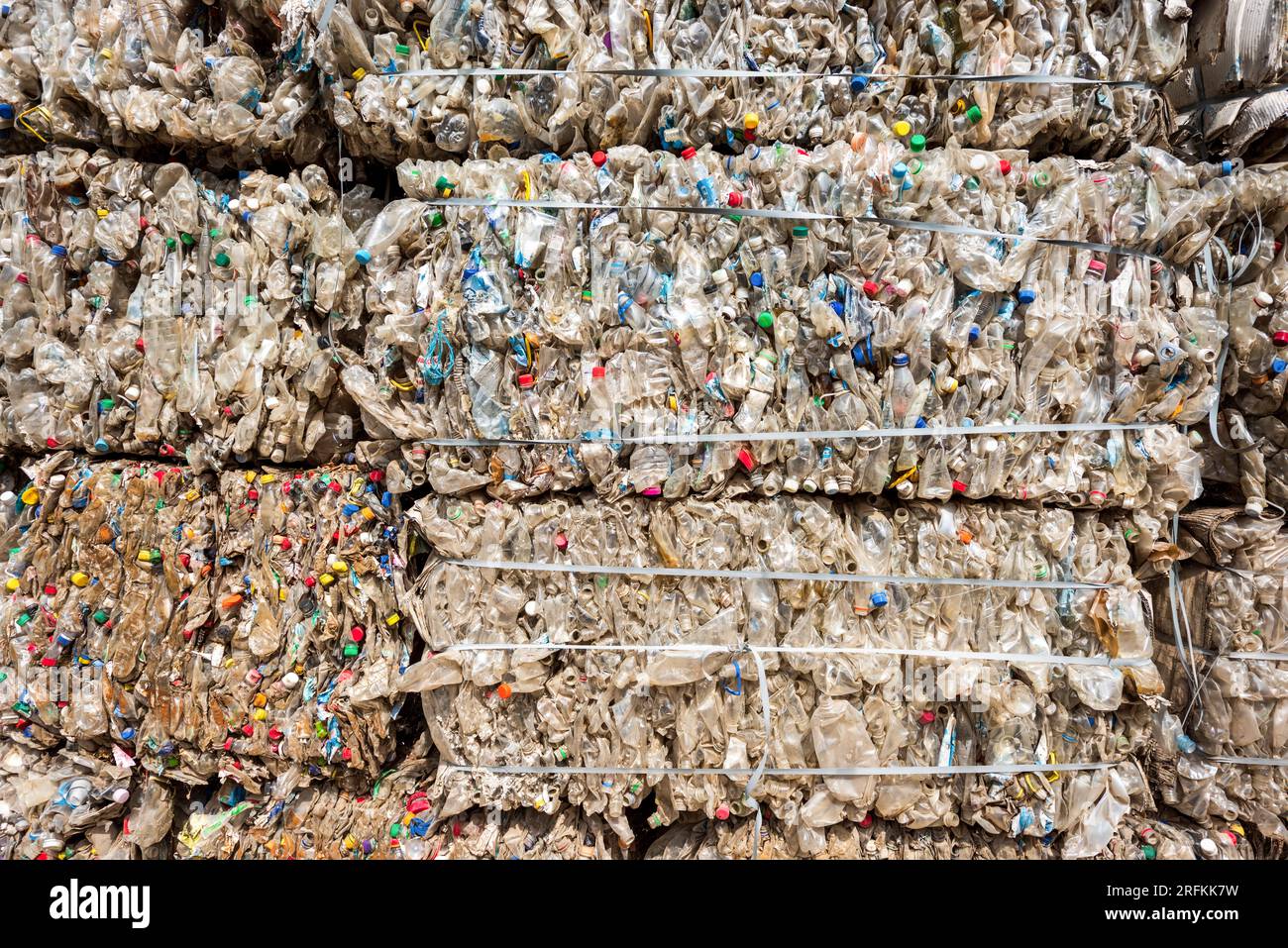 Multiple cubes of compressed plastic garbage near the waste recycling