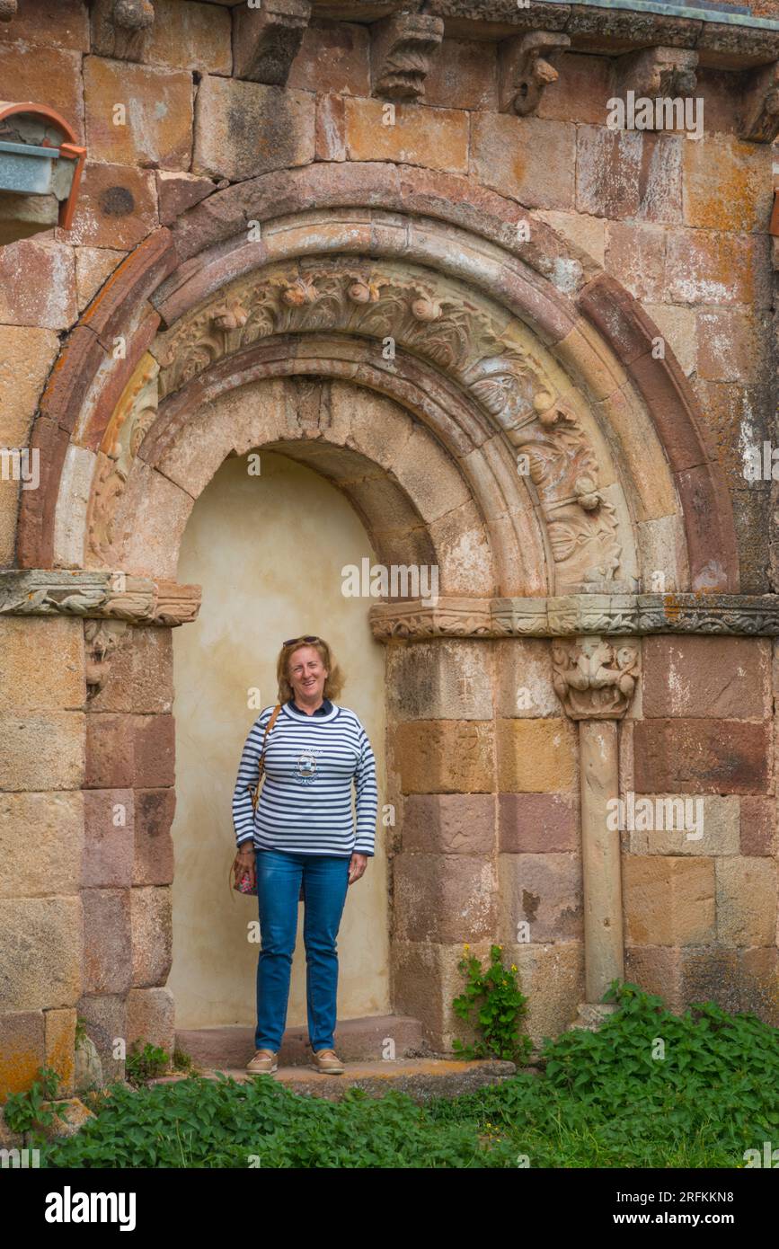 Tourist at the Romanesque portico of the church. Brañosera, Palencia province, Castilla Leon, Spain. Stock Photo