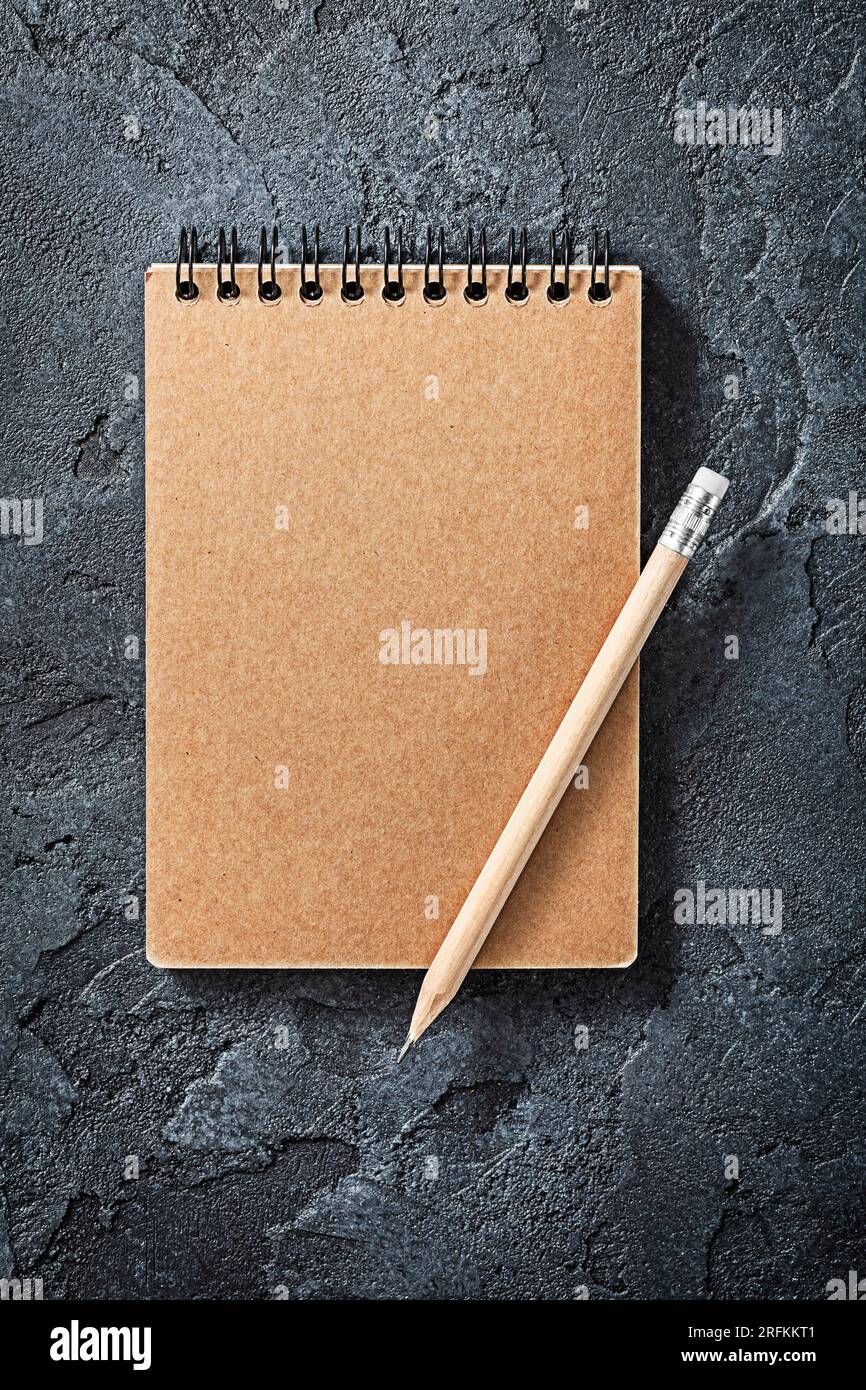Wooden Pencil On Opened Notepad Black Stone Background Stock Photo