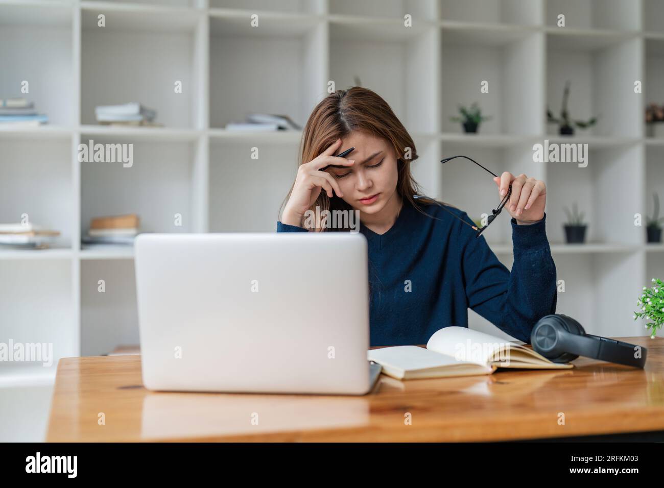 Tired asian woman bored with of laptop sad and frustrated about ...