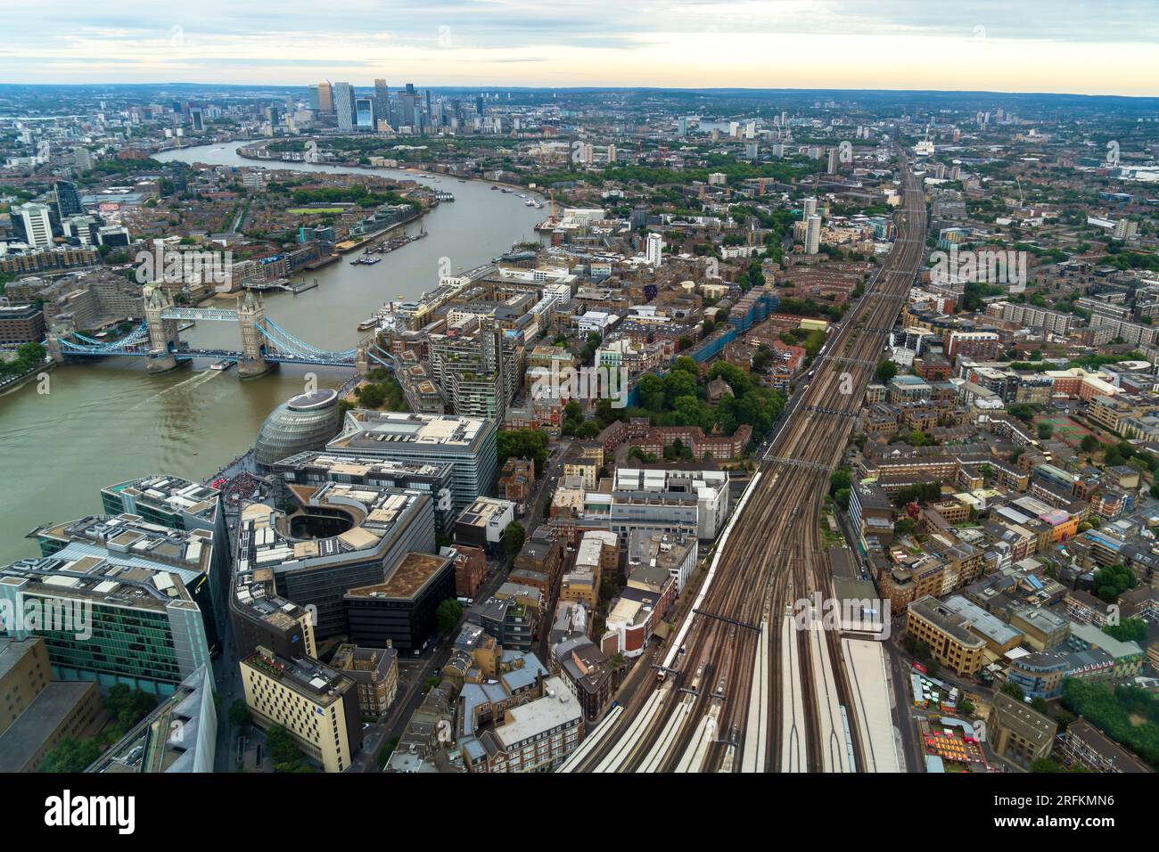 London, England, UK - July 26, 2023. Aerial panoramic view, a cityscape of the modern London skyline with boats on the River Thames and Tower Bridge. Stock Photo