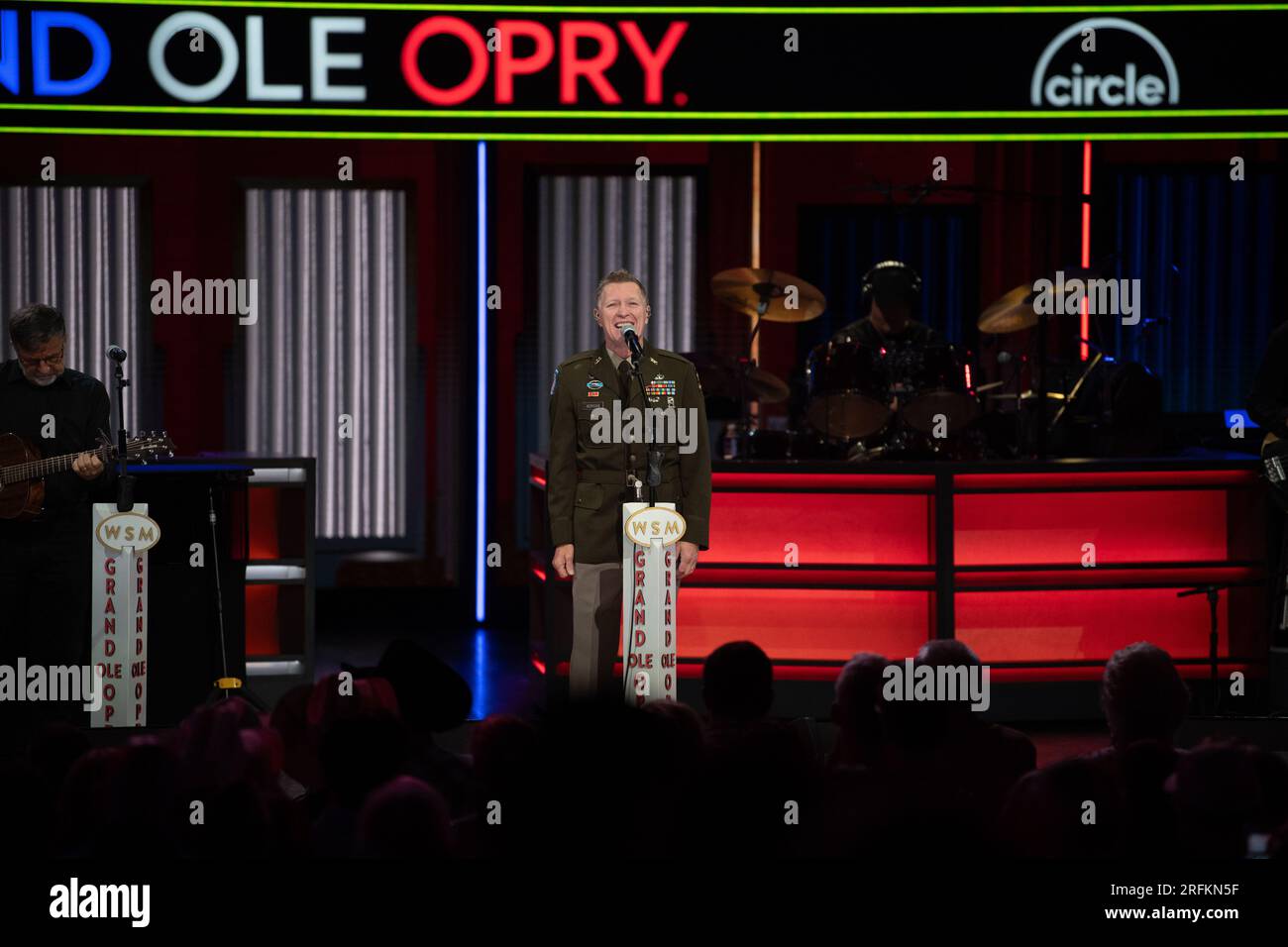 Nashville, United States. 29 July, 2023. Country music artist Craig Morgan, center, performs wearing his army uniform onstage at the historic Grand Ole Opry, July 29, 2023 in Nashville, Tennessee, USA. The 59-year-old singer took the oath of service and reenlisted in the Army Reserves during his show and will serve as a Warrant Officer.  Credit: Lara Poirrier/U.S Army Photo/Alamy Live News Stock Photo