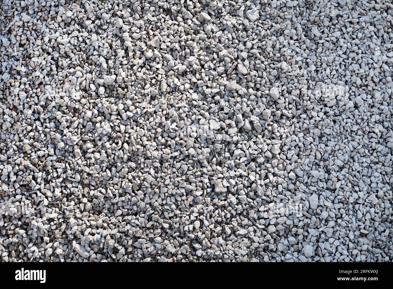 Natural Gray limestone Chippings, Macadam, Rubble or Crushed Stones Background Top View. Macro Stock Photo
