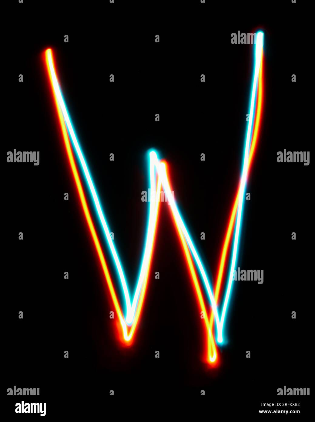 Letter W of the alphabet made from neon sign. The blue red light image, long exposure with colored fairy lights, against a black background Stock Photo